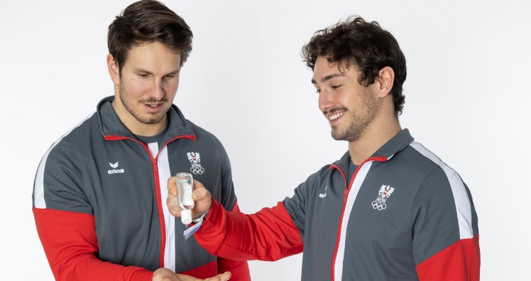 Die Rodel-Doppelsitzer Thomas Steu und Lorenz Koller mit Händedesinfektionsgel von Hagleitner